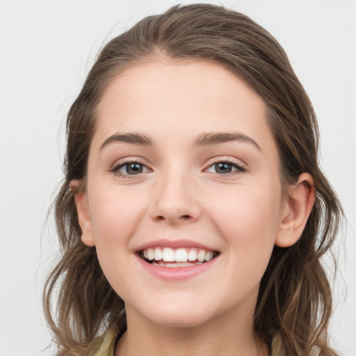 Joyful white young-adult female with long  brown hair and grey eyes