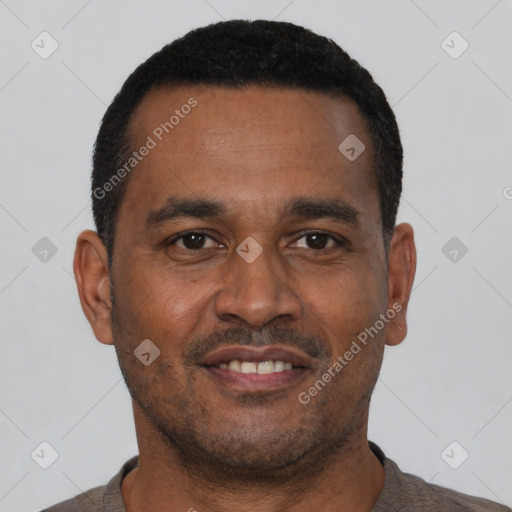 Joyful black young-adult male with short  black hair and brown eyes