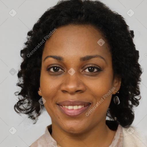 Joyful black adult female with medium  brown hair and brown eyes