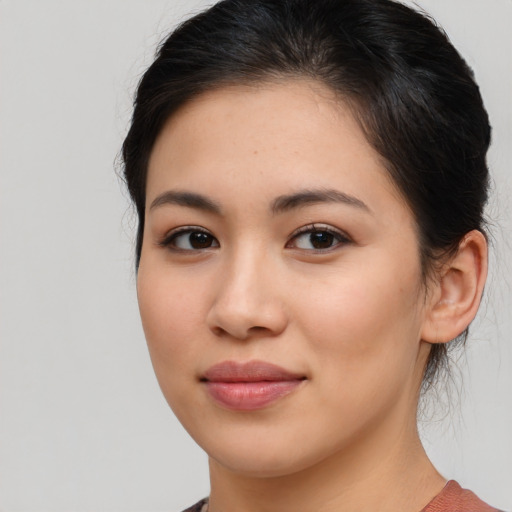 Joyful asian young-adult female with medium  brown hair and brown eyes