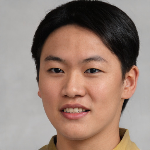 Joyful asian young-adult male with short  brown hair and brown eyes