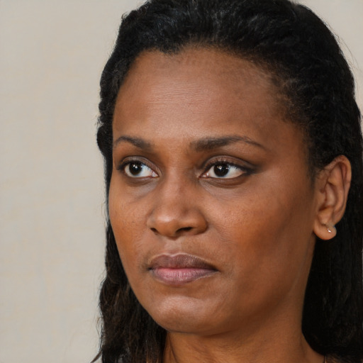 Neutral black young-adult female with long  brown hair and brown eyes