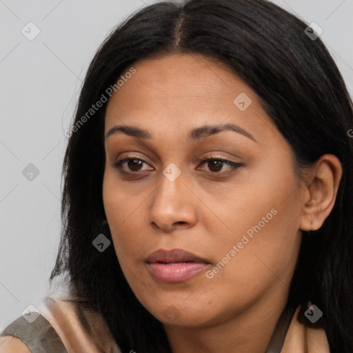 Joyful latino young-adult female with long  brown hair and brown eyes