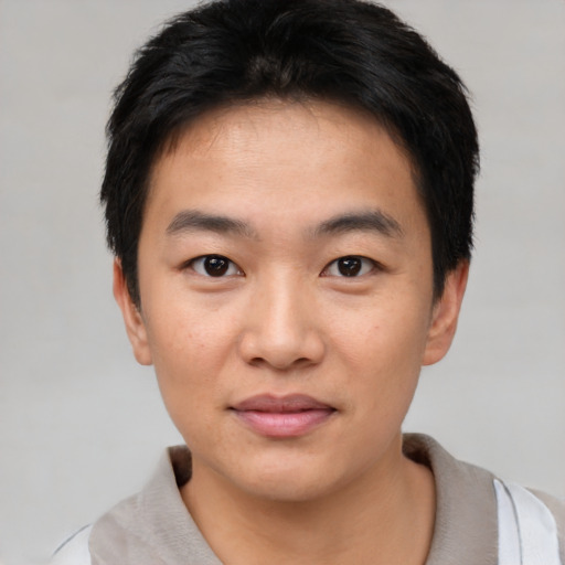 Joyful asian young-adult male with short  black hair and brown eyes
