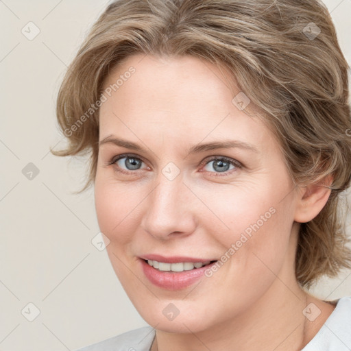 Joyful white young-adult female with medium  brown hair and blue eyes