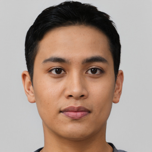 Joyful asian young-adult male with short  black hair and brown eyes