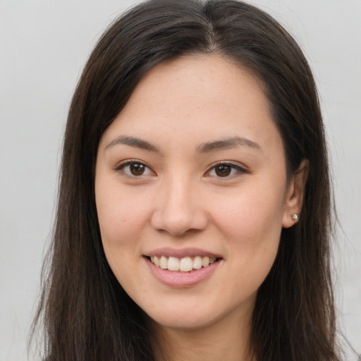 Joyful white young-adult female with long  brown hair and brown eyes