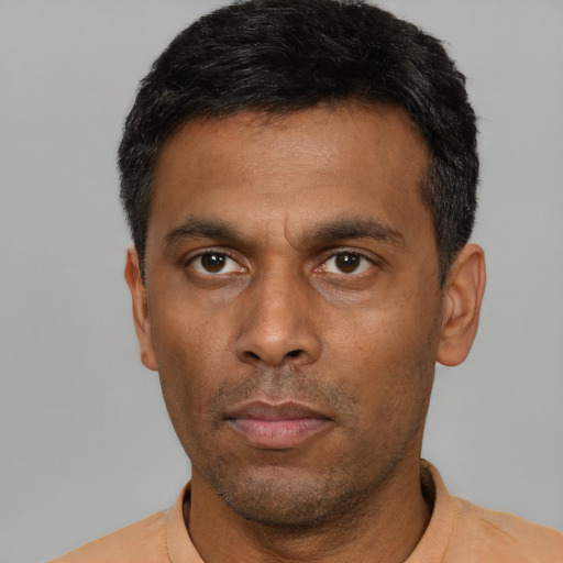 Neutral latino adult male with short  black hair and brown eyes