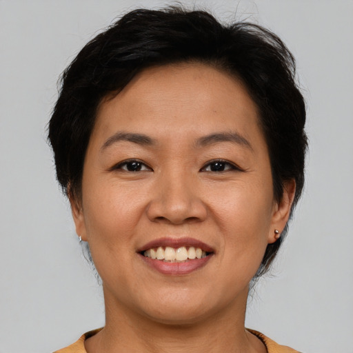 Joyful asian young-adult female with short  brown hair and brown eyes