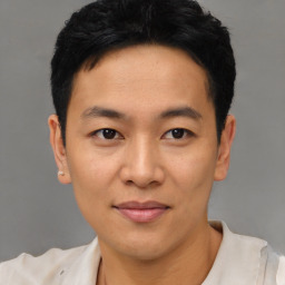 Joyful asian young-adult male with short  black hair and brown eyes