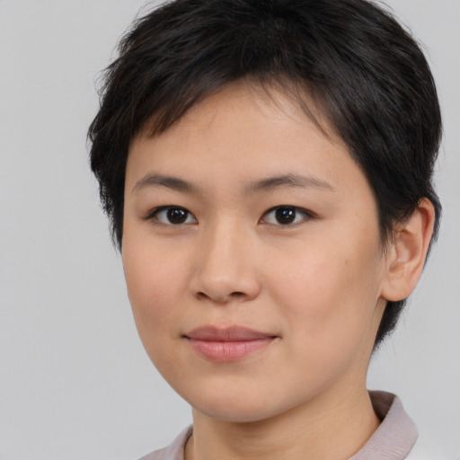 Joyful asian young-adult female with short  brown hair and brown eyes