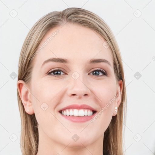 Joyful white young-adult female with long  brown hair and blue eyes