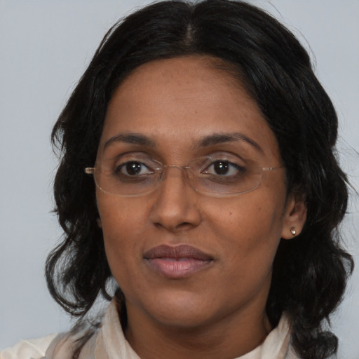 Joyful asian adult female with medium  brown hair and brown eyes