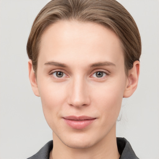 Joyful white young-adult female with short  brown hair and grey eyes