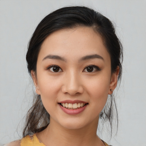 Joyful asian young-adult female with medium  brown hair and brown eyes