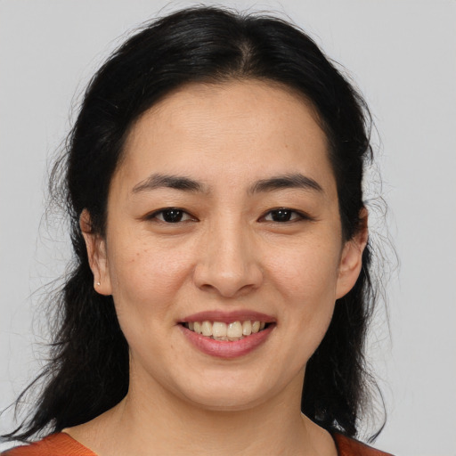 Joyful asian young-adult female with medium  brown hair and brown eyes