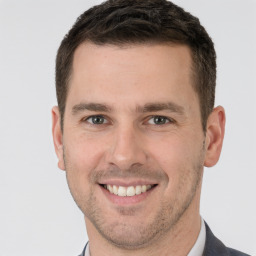 Joyful white young-adult male with short  brown hair and brown eyes