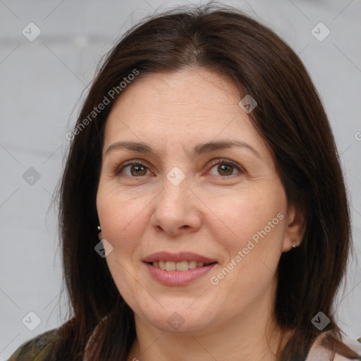 Joyful white adult female with medium  brown hair and brown eyes