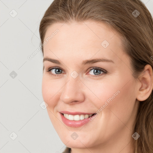 Joyful white young-adult female with long  brown hair and grey eyes