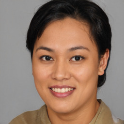 Joyful asian young-adult female with medium  brown hair and brown eyes