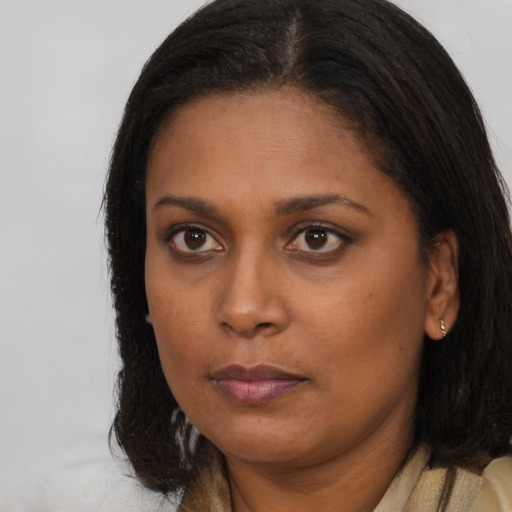 Neutral black young-adult female with long  brown hair and brown eyes