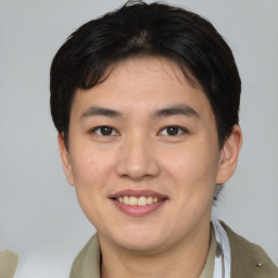 Joyful asian young-adult male with short  brown hair and brown eyes