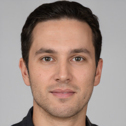 Joyful white young-adult male with short  brown hair and brown eyes