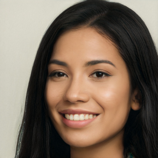 Joyful latino young-adult female with long  brown hair and brown eyes