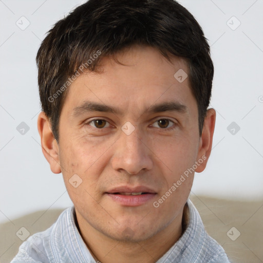 Joyful white adult male with short  brown hair and brown eyes