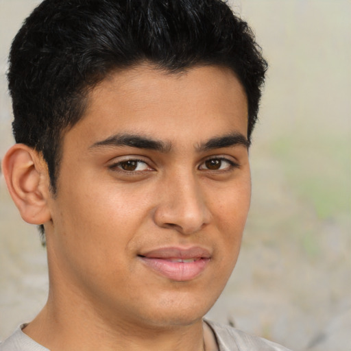 Joyful latino young-adult male with short  brown hair and brown eyes