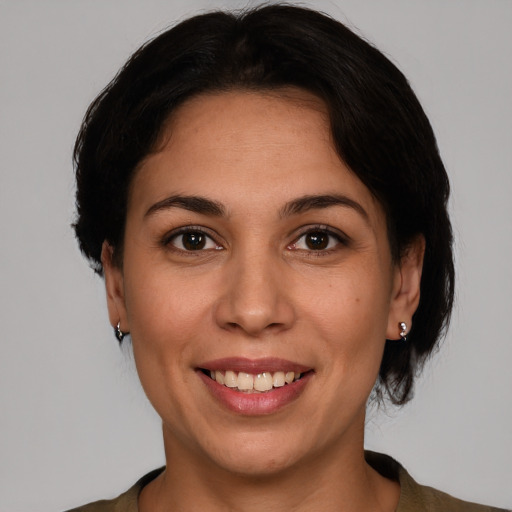 Joyful white adult female with short  brown hair and brown eyes