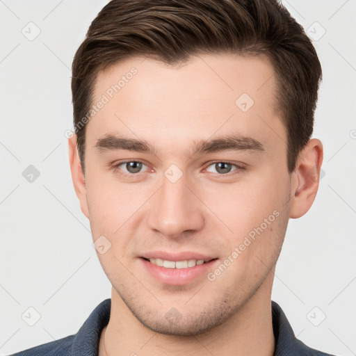 Joyful white young-adult male with short  brown hair and brown eyes