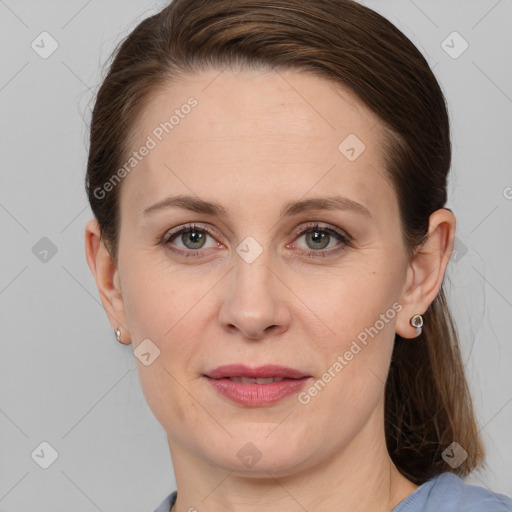 Joyful white adult female with medium  brown hair and grey eyes