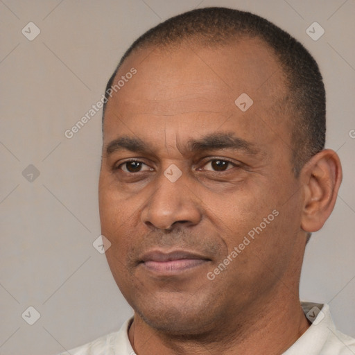 Joyful latino adult male with short  brown hair and brown eyes