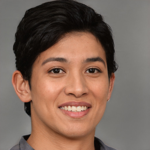 Joyful latino young-adult female with short  black hair and brown eyes