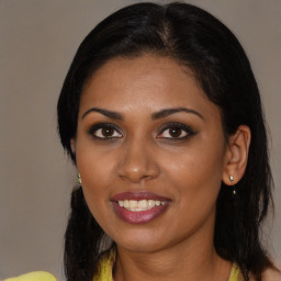 Joyful black young-adult female with medium  brown hair and brown eyes