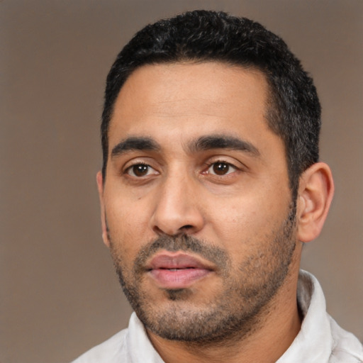 Neutral latino young-adult male with short  black hair and brown eyes