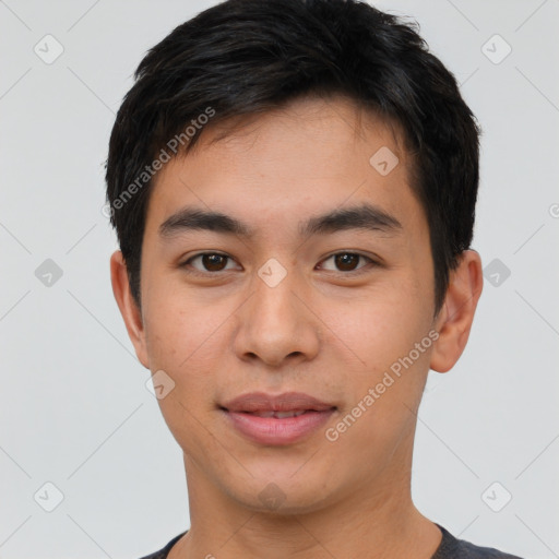 Joyful asian young-adult male with short  brown hair and brown eyes