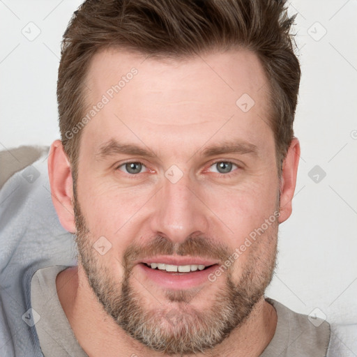 Joyful white adult male with short  brown hair and grey eyes