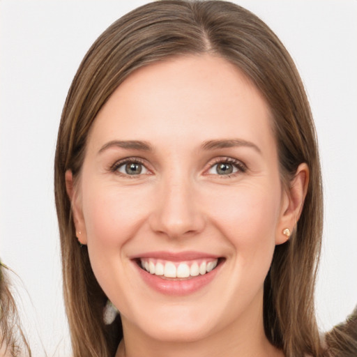 Joyful white young-adult female with long  brown hair and brown eyes