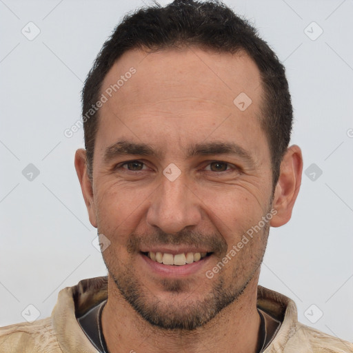 Joyful white adult male with short  brown hair and brown eyes