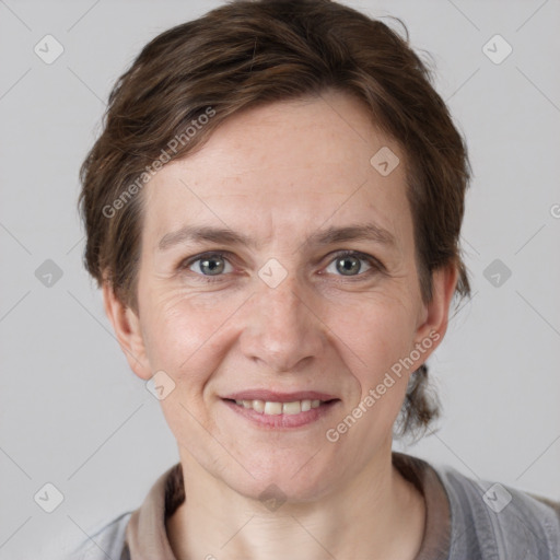 Joyful white adult female with short  brown hair and grey eyes