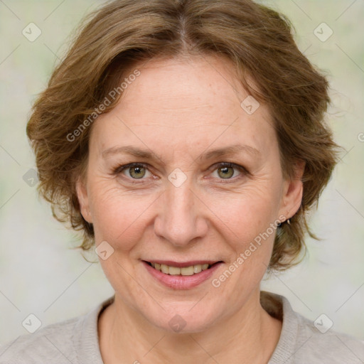 Joyful white adult female with medium  brown hair and green eyes