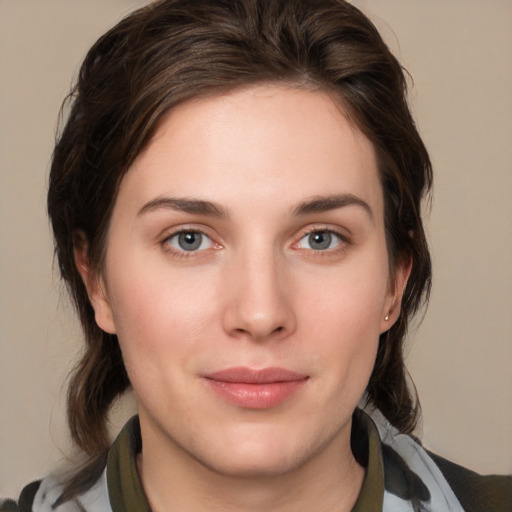 Joyful white young-adult female with medium  brown hair and brown eyes