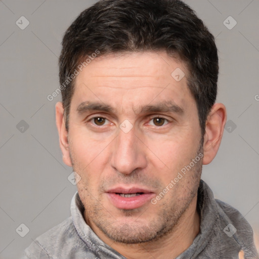 Joyful white adult male with short  brown hair and brown eyes