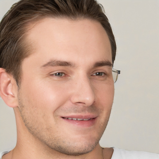 Joyful white young-adult male with short  brown hair and grey eyes