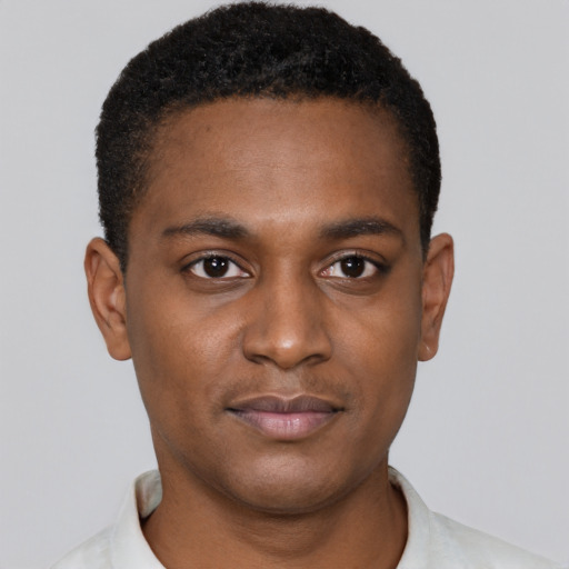 Joyful black young-adult male with short  black hair and brown eyes