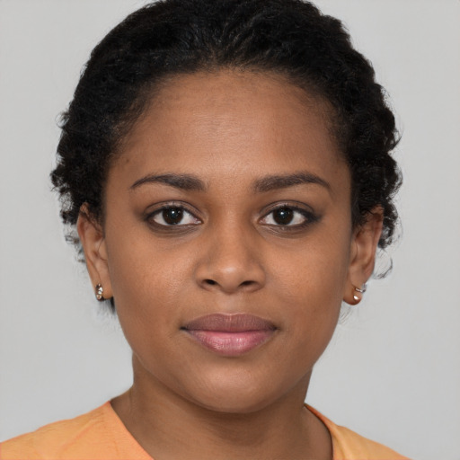 Joyful black young-adult female with short  brown hair and brown eyes