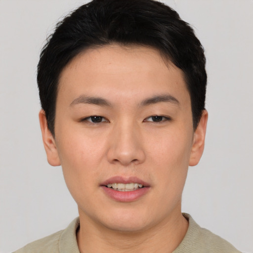 Joyful asian young-adult male with short  black hair and brown eyes