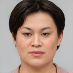 Joyful asian young-adult female with short  brown hair and brown eyes